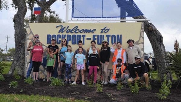 Mid-Coast Chapter members help Keep Aransas County Beautiful plant native plants at the city signs